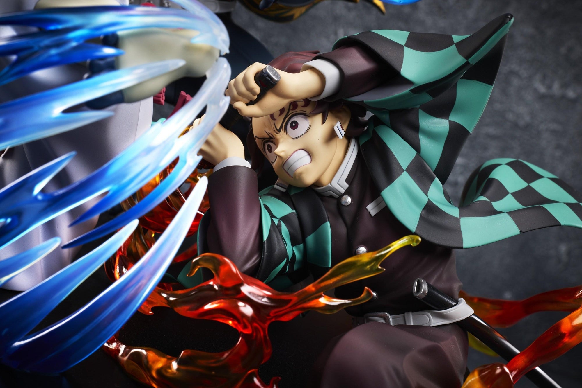 Close-up of Tanjiro Kamado in checkered haori with Hinokami Kagura flame effects surrounding his Nichirin sword