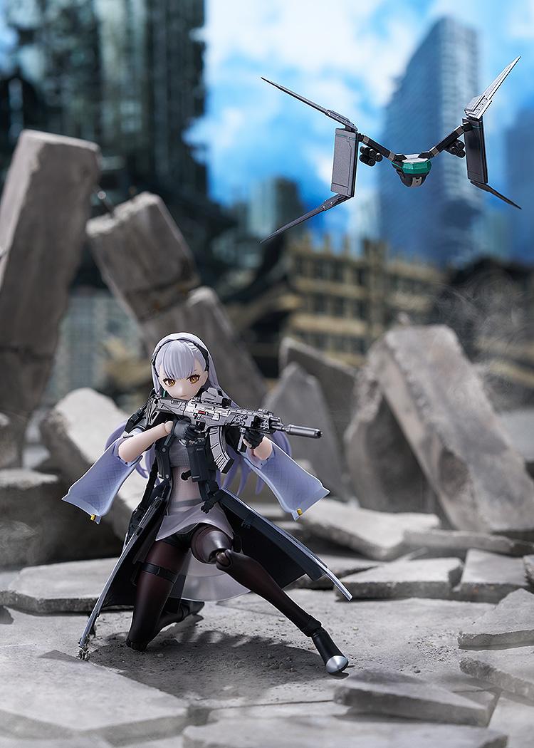 Tactical crouching action pose of the Tololo figma figure aiming her Planeta rifle on a ruined concrete battlefield diorama with her floating drone nearby.
