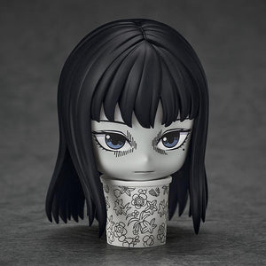 Close-up of Nendoroid Tomie with a displeased face plate displayed inside the floral trash can accessory.