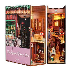 Product shot of the assembled Tonecheer DIY book end, showcasing the Japanese storefront and the warmly lit interior alley.