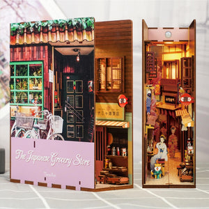 The assembled "The Japanese Grocery Store" book nook displayed next to its front cover, showing the deep interior alley and storefront facade.