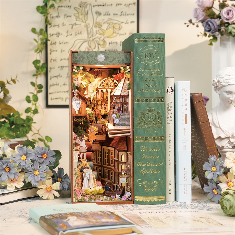 The assembled "Shakespeare's Verse" book nook placed on a desk next to books, demonstrating its use as a unique bookshelf insert.
