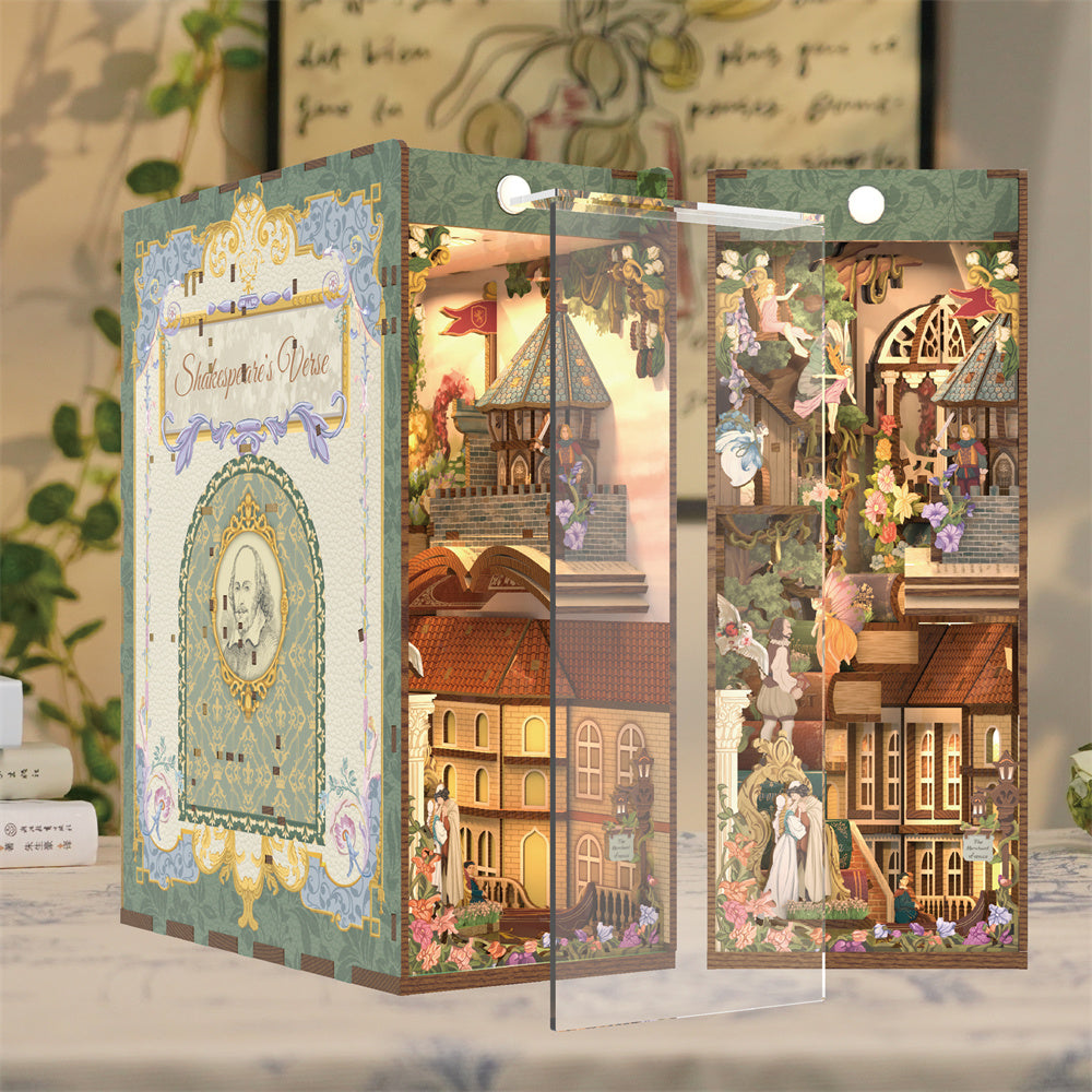 The assembled book nook kit displayed with the included transparent dust cover piece being placed over the detailed interior scene.