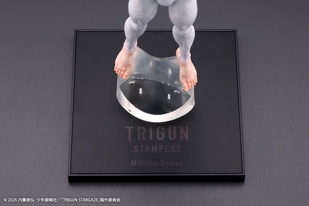 Close-up of the black display base printed with Trigun Stampede Millions Knives logo and clear magnetic foot stand