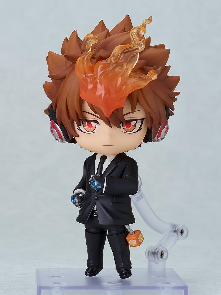 Full-body standing shot of the Tsuna Sawada Nendoroid in a formal black suit with X-Headphones.