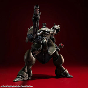 Low angle front-facing shot of the VAKIT Geara Doga Commander Type model kit aiming its long-barreled rifle upward in a dynamic pose.