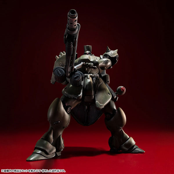 Low angle front-facing shot of the VAKIT Geara Doga Commander Type model kit aiming its long-barreled rifle upward in a dynamic pose.