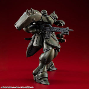 Full front standing view of the painted green VAKIT Geara Doga Normal Type model kit, displaying its articulation and weathered military aesthetic.