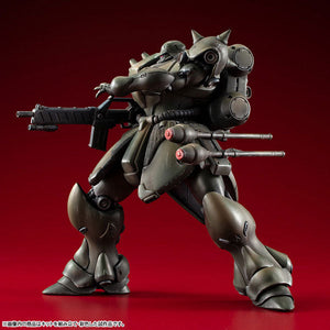 Dynamic side-profile action pose of the painted MegaHouse VAKIT Geara Doga Standard Type model kit, showcasing its full articulation against a red gradient background.