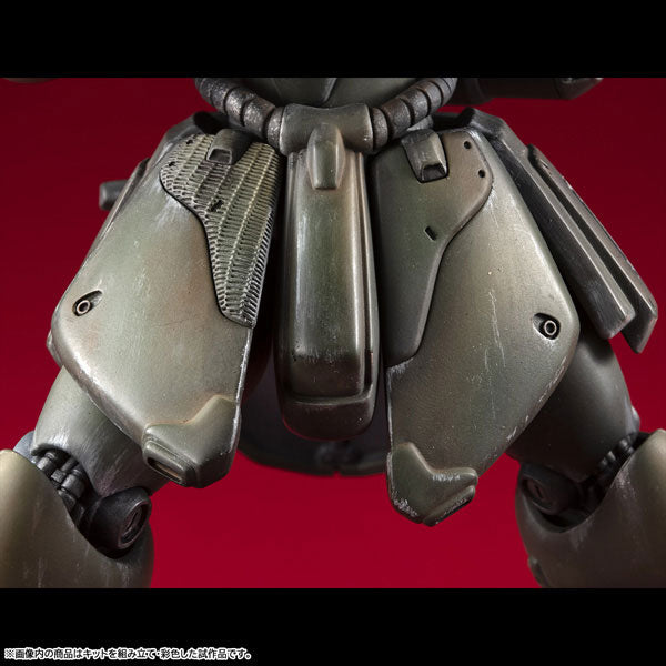 Macro close-up view highlighting the intricate mechanical detailing and weathered paint application on the front waist armor of the Geara Doga model kit.