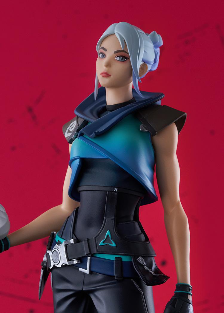 Detailed portrait close-up of Jett face sculpt and blue gradient top against a red background