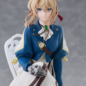 Upper body close-up of Violet Evergarden figure featuring her emerald brooch, blue jacket, and metallic prosthetic hands