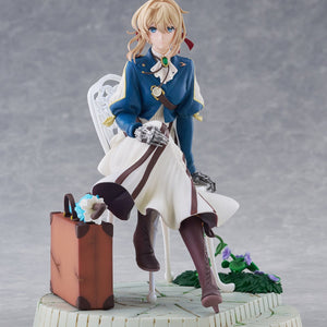 Full front view of Taito Violet Evergarden DRESSTA figure sitting on a white chair next to a suitcase on a stone base