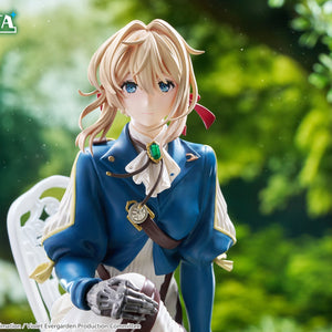 Tight portrait close-up shot of Violet Evergarden displaying her blue eyes, blonde hair, and emerald brooch in natural lighting