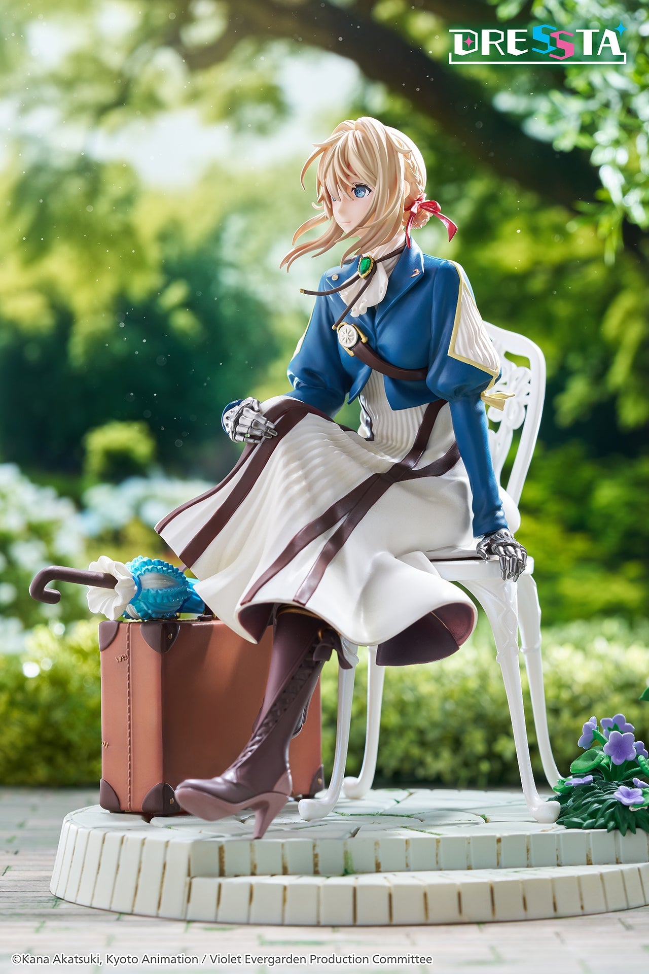 Low-angle side diorama view of Violet Evergarden seated on a garden chair next to her brown suitcase
