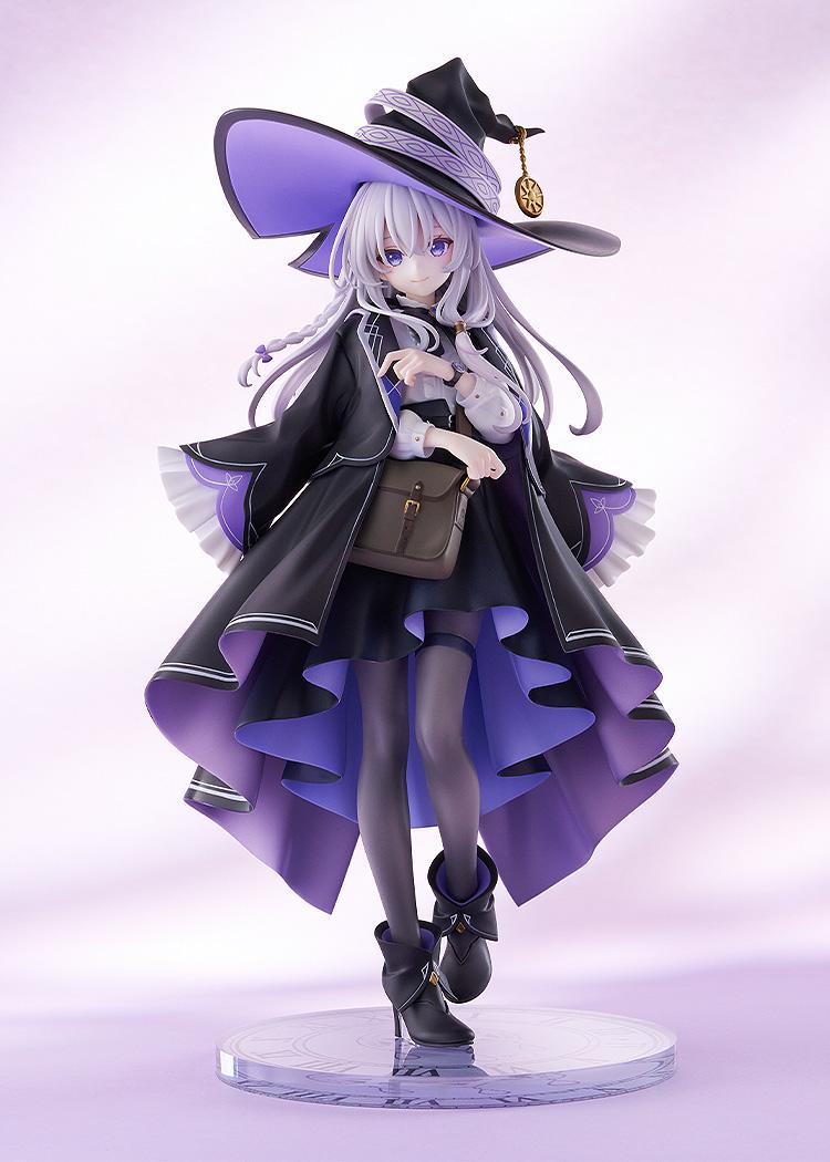 Front view of Elaina 1/7 scale figure in her pointed witch hat and black cloak with purple lining on a soft lavender background.