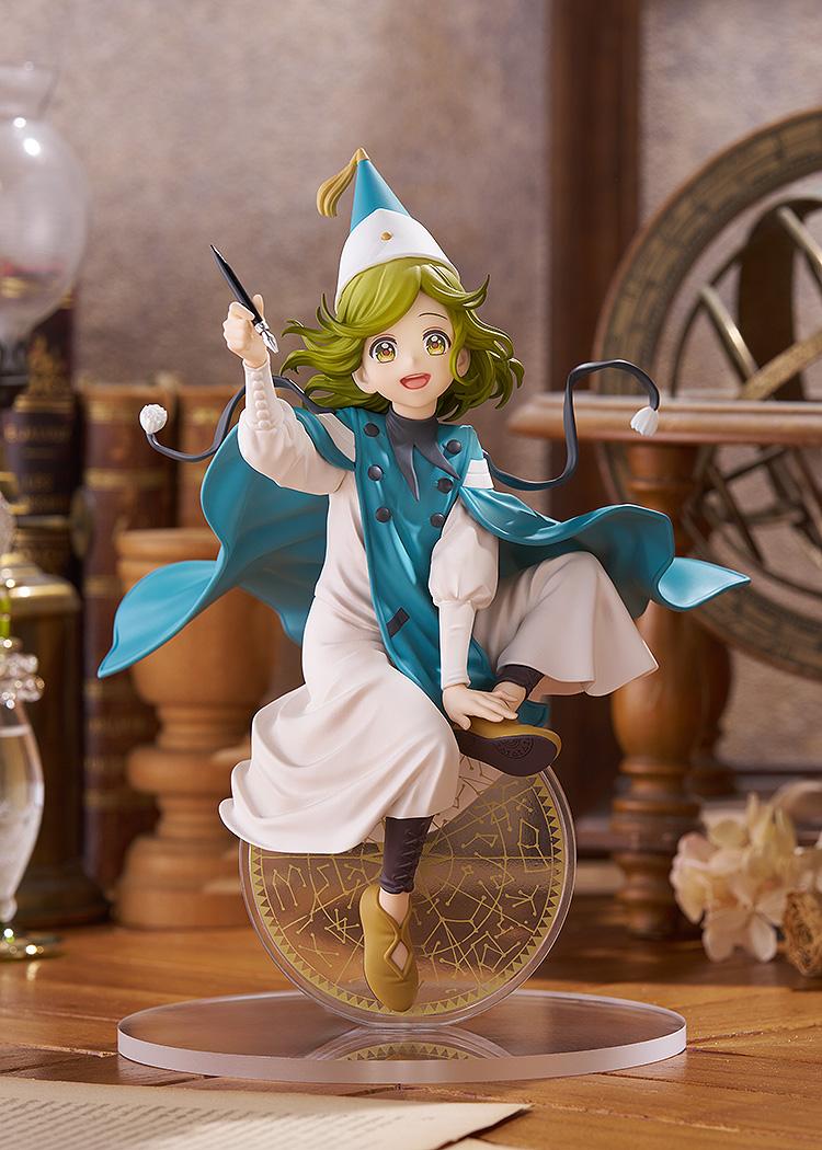 Full-body scenic showcase of the Coco figure displayed on a wooden desk within a vintage magic atelier diorama containing an astrolabe and antique books.