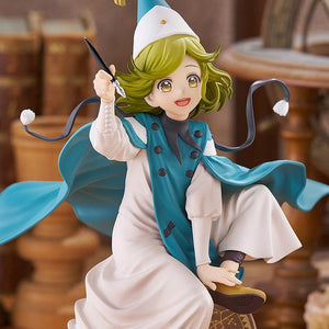 Medium shot of the Coco POP UP PARADE L figure holding her fountain pen accessory upward, set against a warm, out-of-focus laboratory background.