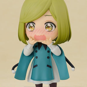 Front view of the 10cm Coco Nendoroid figure with her pointy hat removed, showcasing her highly detailed excited face plate with bright blushing cheeks and hands held up to her mouth.