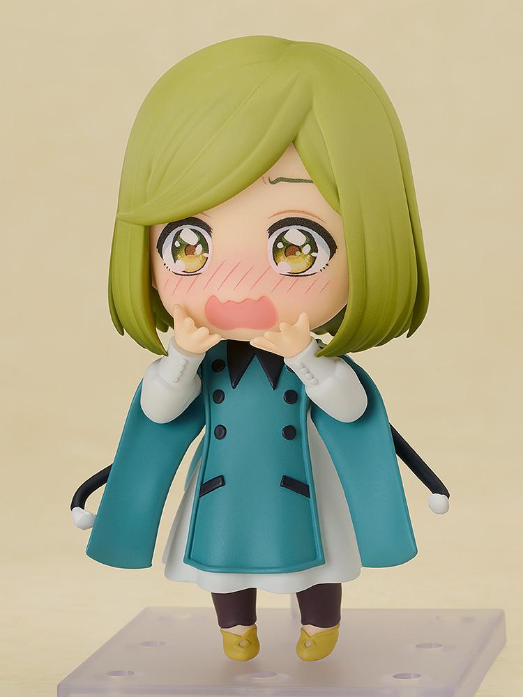 Front view of the 10cm Coco Nendoroid figure with her pointy hat removed, showcasing her highly detailed excited face plate with bright blushing cheeks and hands held up to her mouth.
