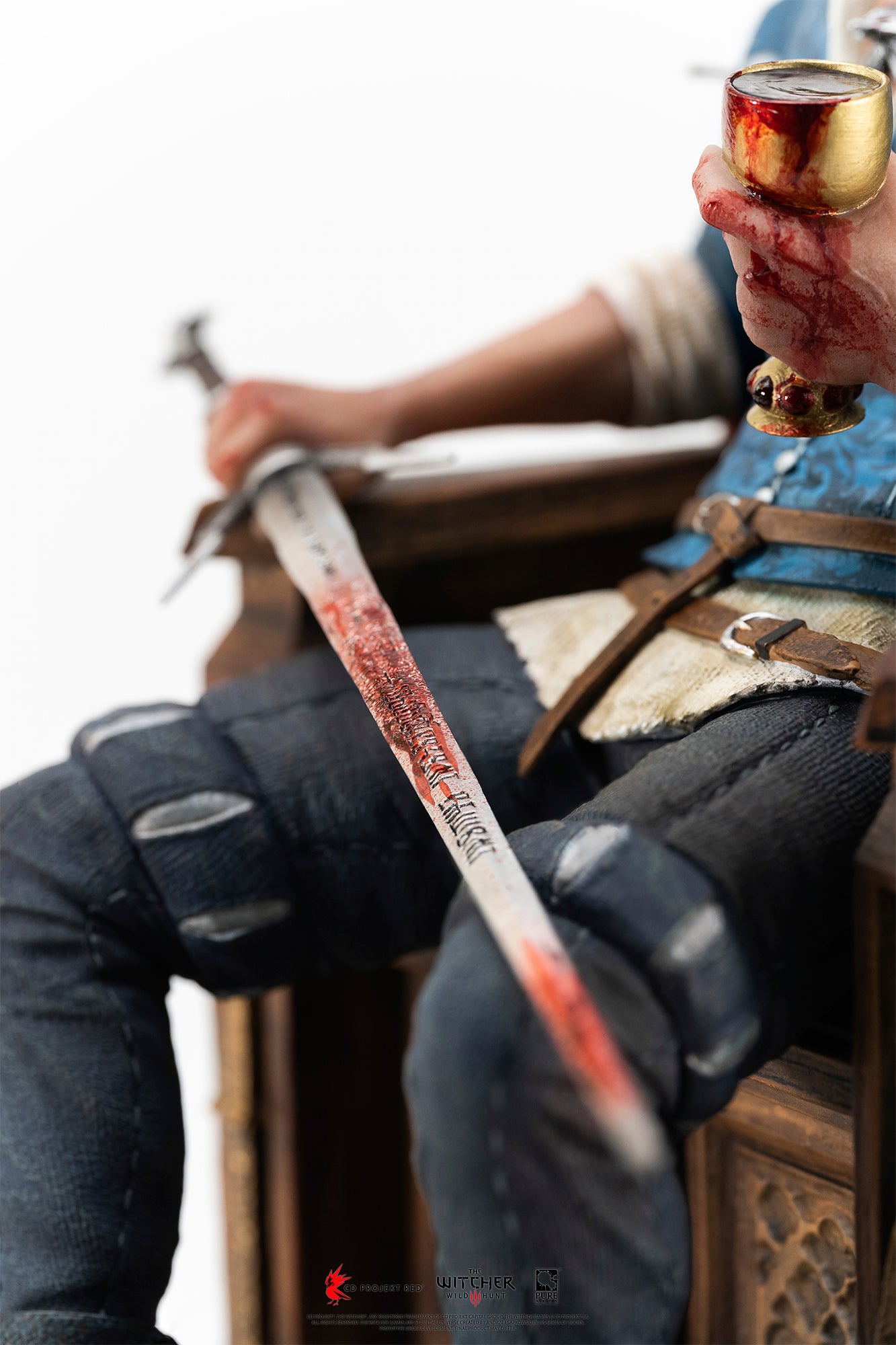 Close-up view of Geralt holding a blood-splattered silver sword and a golden chalice from The Witcher 3 1/6 scale statue by PureArts.