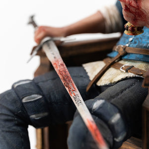 Close-up view of Geralt holding a blood-splattered silver sword and a golden chalice from The Witcher 3 1/6 scale statue by PureArts.