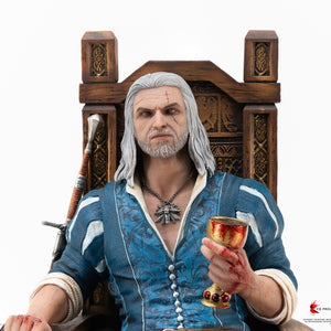 Front waist-up view of Geralt of Rivia seated on his throne holding his chalice and resting his silver sword across his lap.