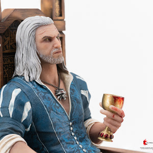 Medium portrait shot of Geralt sitting on a high-backed wooden throne in his blue Blood and Wine doublet holding a chalice.