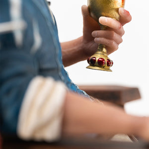 Side-angle close-up of Geralt's hand holding an ornate jewel-encrusted goblet filled with blood.