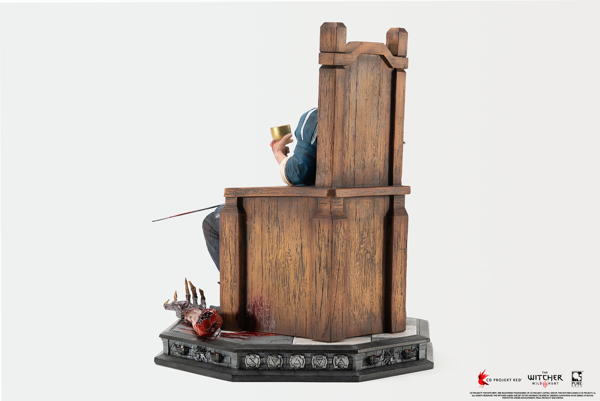 Left side profile view of the Geralt 1/6 scale statue detailing the throne construction and severed vampire arm on the base.
