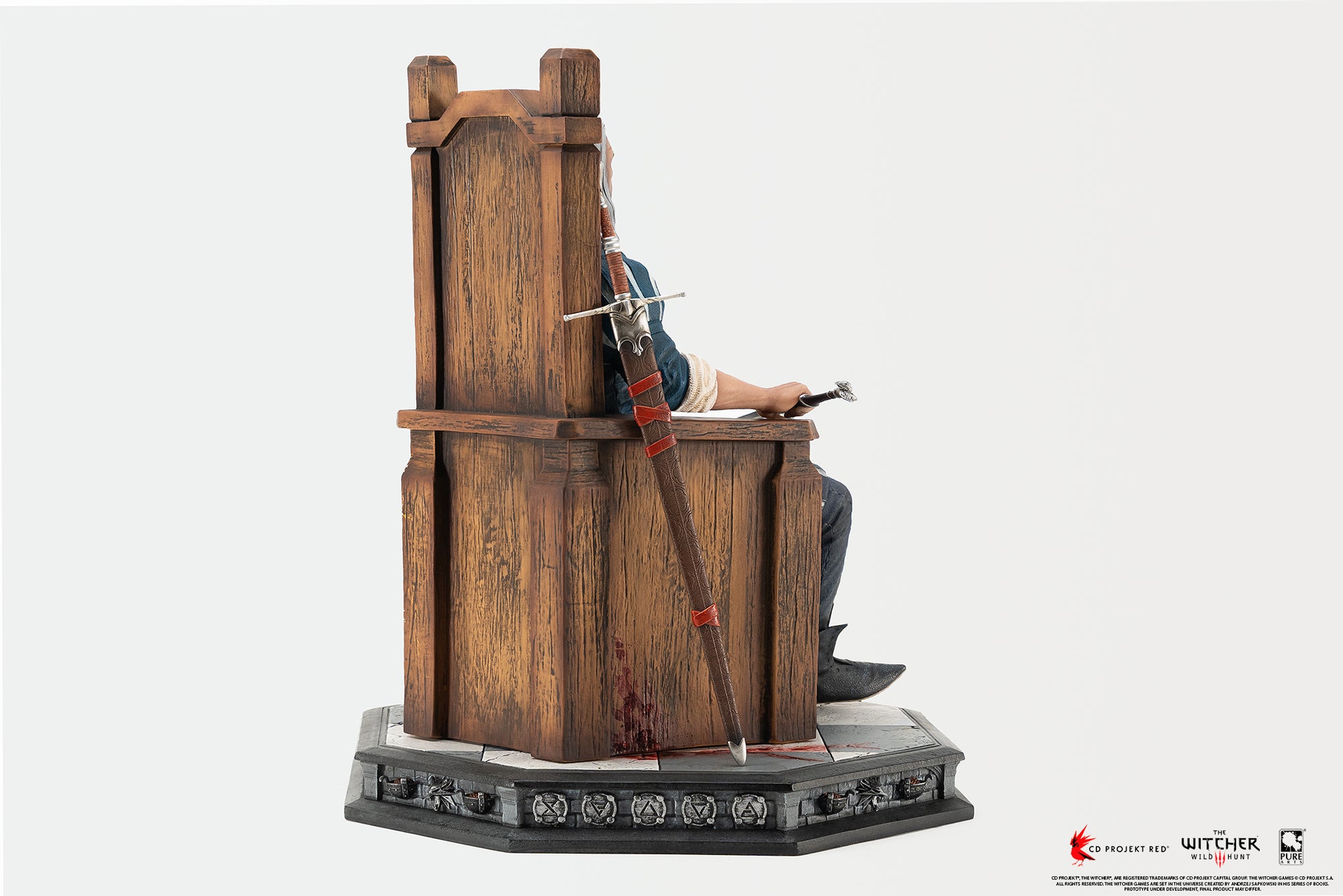 Rear three-quarter perspective of the PureArts Geralt statue showing the wooden throne back and scabbard placement.