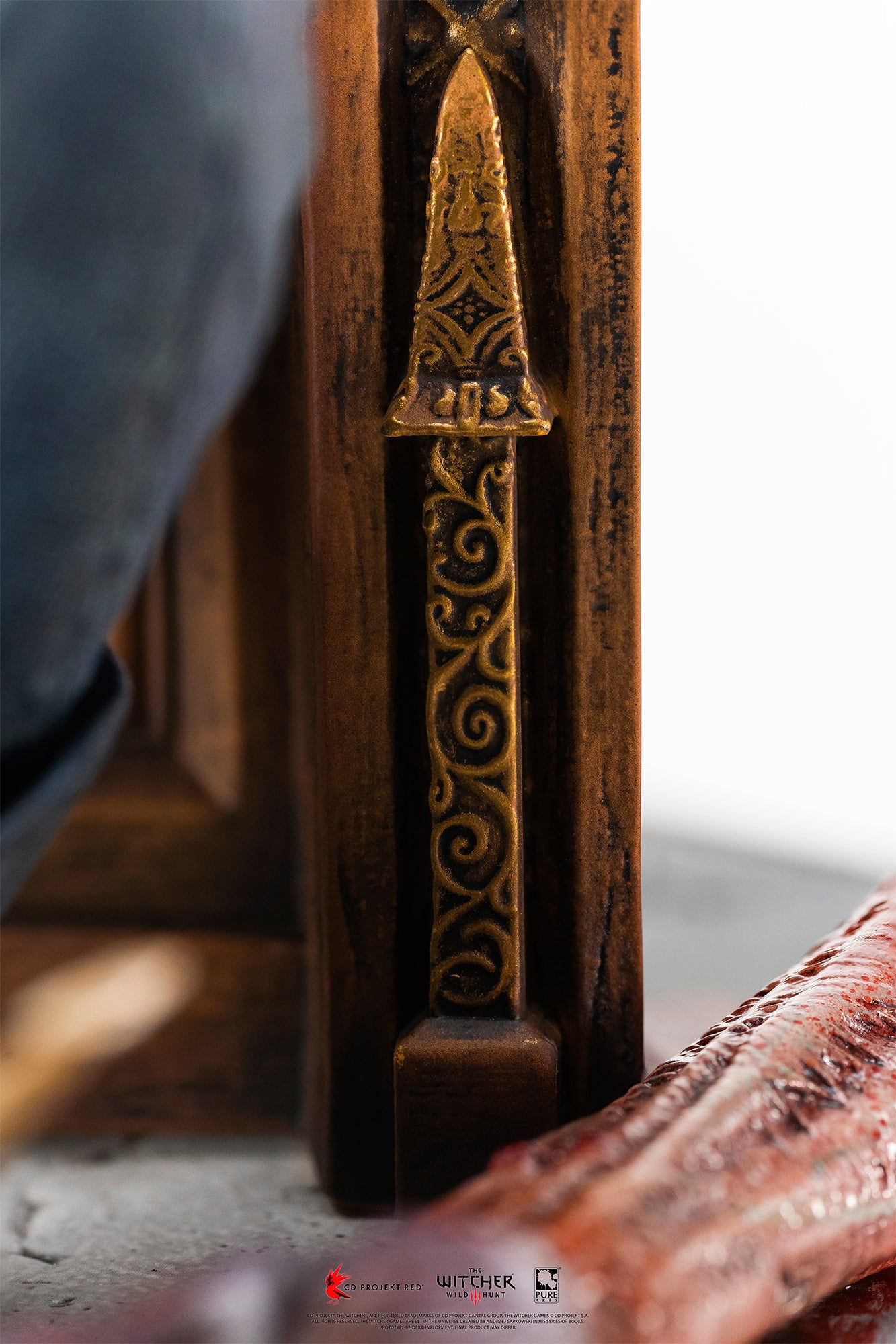 Macro view highlighting the intricate gold filigree wood carving details on the wooden throne frame.
