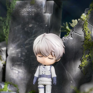 Close-up of Xavier Nendoroid with the sleeping face plate standing against a stone wall.