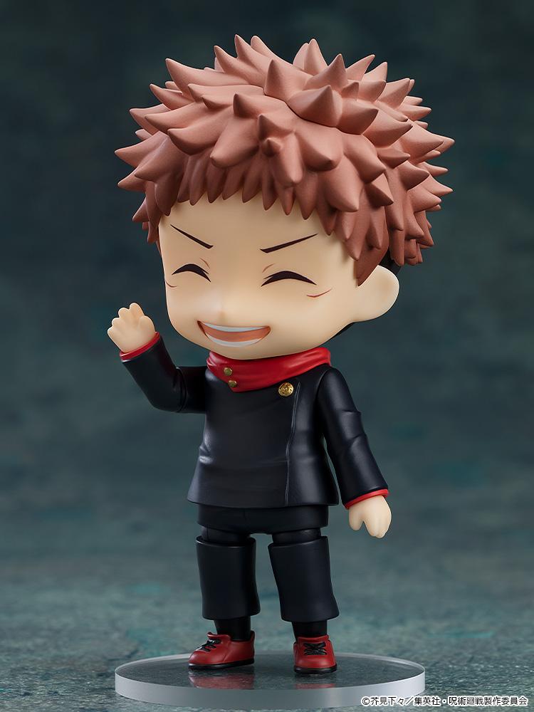Cheerful posing of the Yuji Itadori Nendoroid with eyes closed and a wide grin, waving one hand.