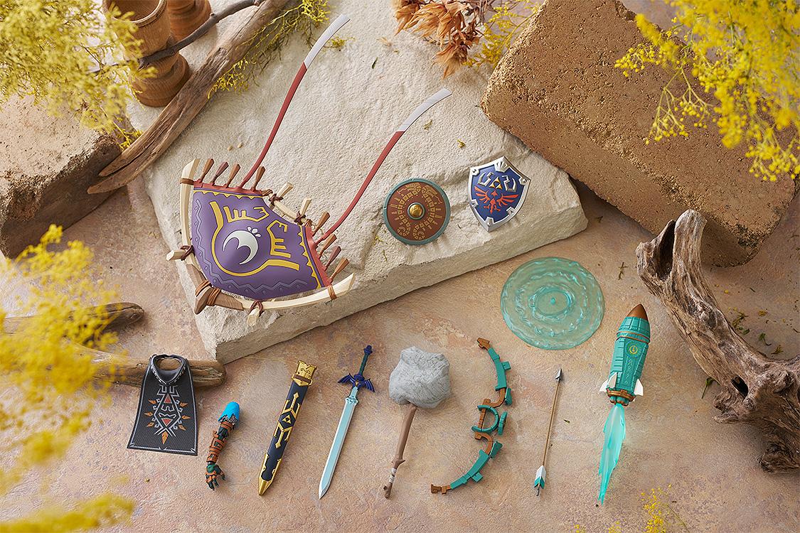 Artistic flatlay of Link's accessories including the Master Sword, Hylian Shield, and various fusion items.