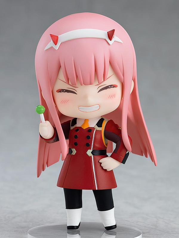 Zero Two Nendoroid figure holding a green sucker accessory with a happy, wide-grinned face plate.