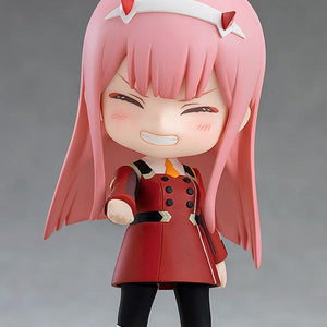 Close-up of the Zero Two Nendoroid with an innocent, closed-eye smile and blushing cheeks.