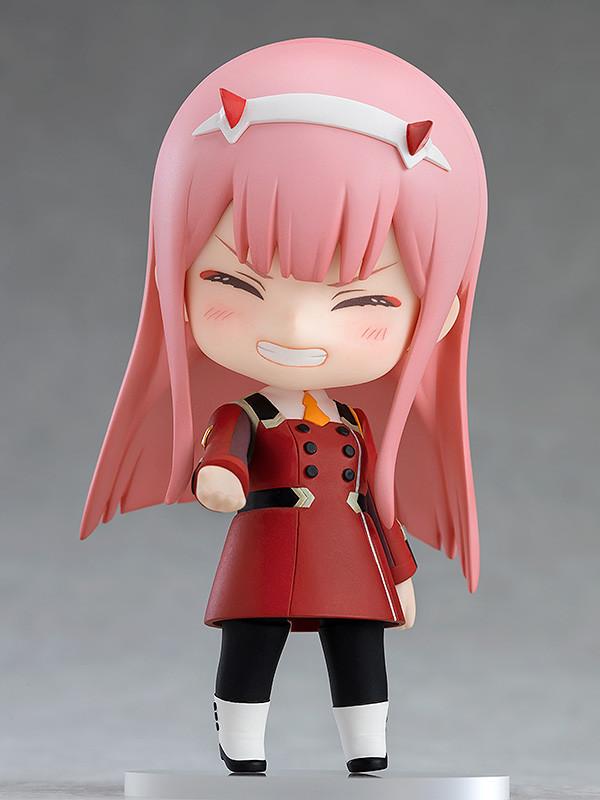 Close-up of the Zero Two Nendoroid with an innocent, closed-eye smile and blushing cheeks.