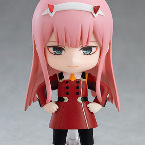 Front view of the Zero Two Nendoroid standing on a clear base with her hands on her hips and a fearless smile.