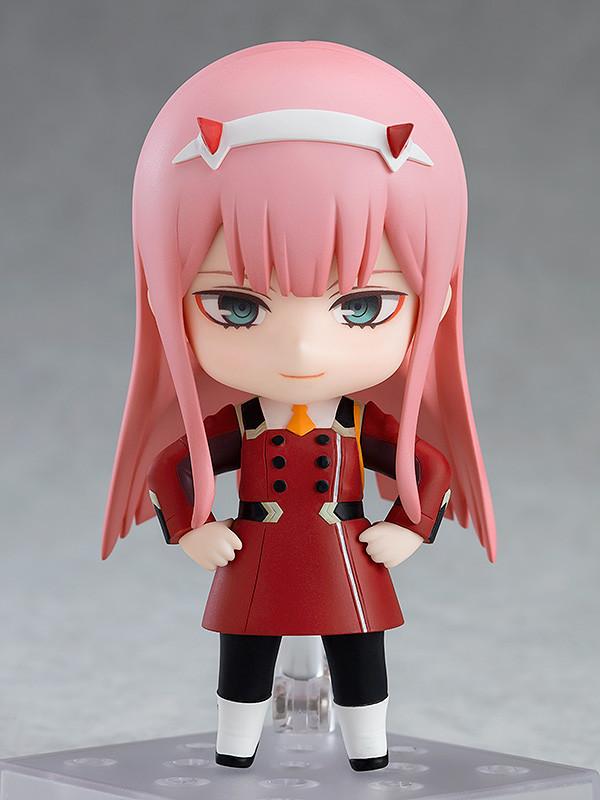 Front view of the Zero Two Nendoroid standing on a clear base with her hands on her hips and a fearless smile.