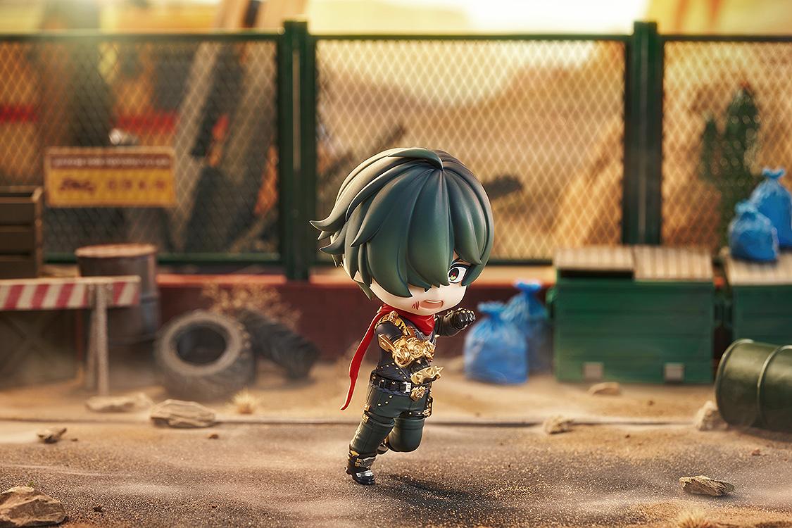 Action diorama shot of the Lighter Nendoroid figure running forward with his golden boxing glove in a desert scrapyard setting.